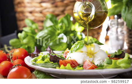Salad with Tomatoes, Burrata, basil,olive oil. middle name Burratina 98259917