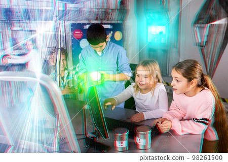 Interested tweens trying to get out of escape room, toned image 98261500