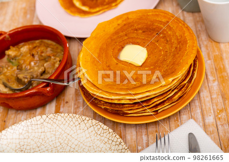 Belarusian machanka with assorted meat served with pancakes Belarusian machanka with assorted meat served with pancakes 98261665