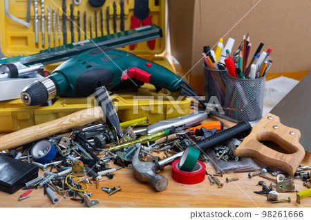 Different screws and tools on the table in the workshop Different screws and tools on the table in the workshop 98261666