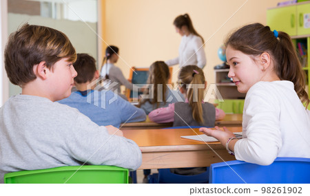 Pupils chattering at lesson 98261902