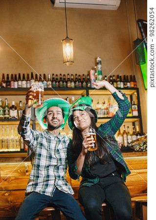 Indian friends celebrate St. Patrick's Day in a pub 98262054
