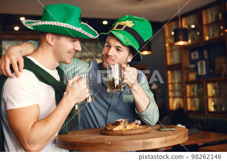 Men celebrate St. Patrick's Day at bar with a mug of beer 98262146