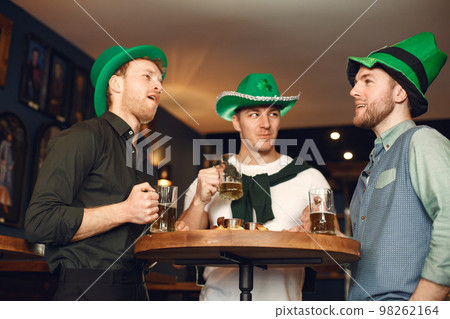 Men celebrate St. Patrick's Day at bar with a mug of beer Men celebrate St. Patrick's Day at bar with a mug of beer 98262164