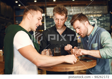 Men celebrate St. Patrick's Day at bar with a mug of beer Men celebrate St. Patrick's Day at bar with a mug of beer 98262172