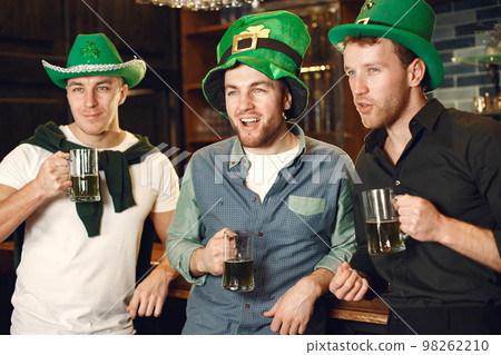 Men celebrate St. Patrick's Day at bar with a mug of beer 98262210