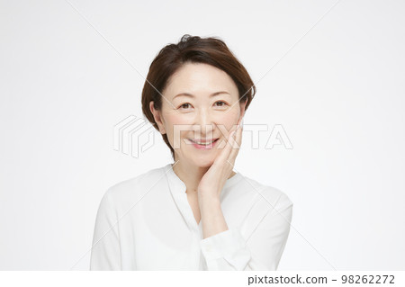 Senior woman doing skin care 98262272