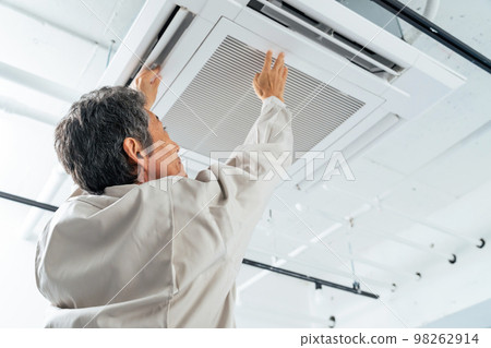 Workers inspecting air conditioners 98262914