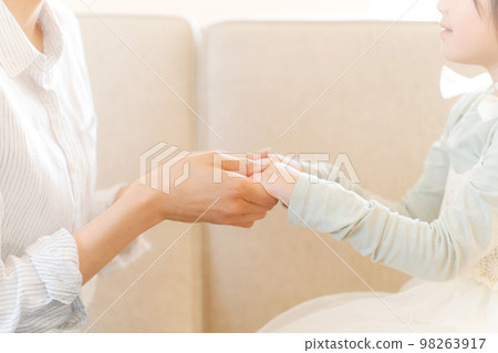 photo of mother and daughter holding hands photo of mother and daughter holding hands 98263917