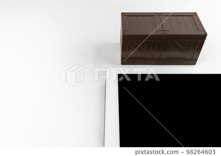 A wooden box of tablets and toys. Storage image of tablet device A wooden box of tablets and toys. Storage image of tablet device 98264603