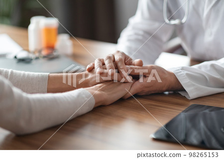 Closeup Shot Of Doctor Man Comforting Female Patient After Sharing Bad Diagnosis Closeup Shot Of Doctor Man Comforting Female Patient After Sharing Bad Diagnosis 98265153