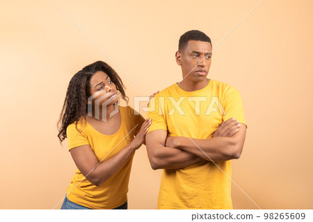 African american lady asking forgiveness after saying wrong words to beloved black boyfriend, yellow background African american lady asking forgiveness after saying wrong words to beloved black boyfriend, yellow background 98265609