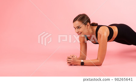 Beautiful Sporty Young Woman Doing Plank Exercise While Training In Studio 98265641