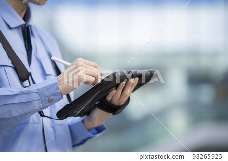 Hands of a man in work clothes typing on a tablet with a pen Photographed in cooperation with "LINK FOREST" Hands of a man in work clothes typing on a tablet with a pen Photographed in cooperation with "LINK FOREST" 98265923