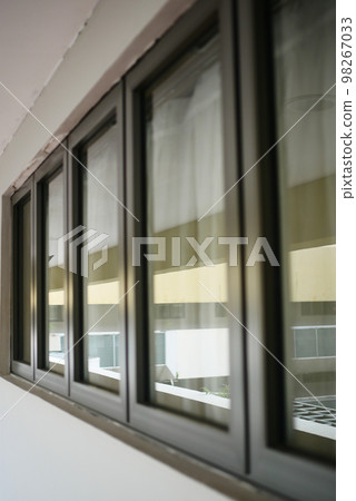 Modern building with tinted windows. Urban architecture 98267033