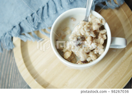 top view of granola Musli and milk in a cup on table top view of granola Musli and milk in a cup on table 98267036