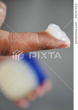 Close up of man hand using petroleum jelly Close up of man hand using petroleum jelly 98267450