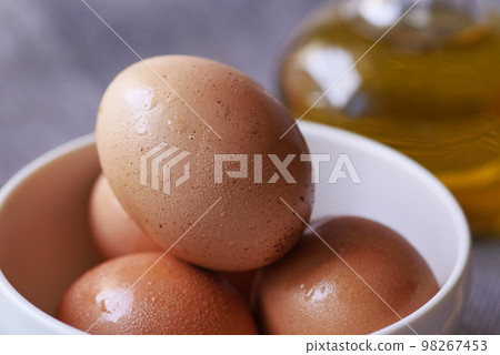 close up of eggs in a bowl. 98267453