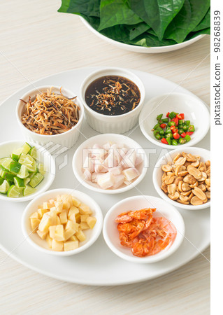 Miang kham - A royal leaf wrap appetizer Miang kham - A royal leaf wrap appetizer 98268839
