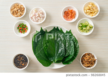 Miang kham - A royal leaf wrap appetizer Miang kham - A royal leaf wrap appetizer 98268845