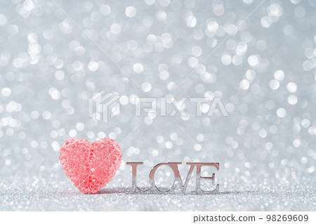 red crystal heart and Love word on grey sparkling background. Gift or holiday concept. Love text Mothers Day, Fathers birthday wedding or St Valentines day with copy space. red crystal heart and Love word on grey sparkling background. Gift or holiday concept. Love text Mothers Day, Fathers birthday wedding or St Valentines day with copy space. 98269609