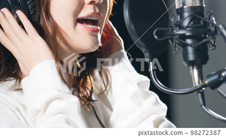 Female singer recording in studio 98272387