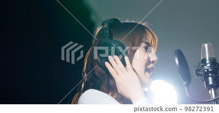 Female singer recording in studio 98272391