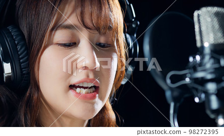 Female singer recording in studio Female singer recording in studio 98272395