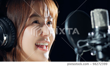 Female singer recording in studio Female singer recording in studio 98272399