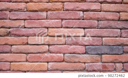 Texture of the wall of old red brick closeup Texture of the wall of old red brick closeup 98272462