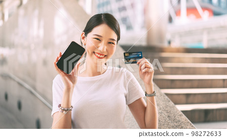 Young adult business woman consumer holding smartphone blank screen space for mockup. Young adult business woman consumer holding smartphone blank screen space for mockup. 98272633