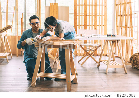 Southeast asian family father and son diy or repair for crafts skill at home workshop 98273095