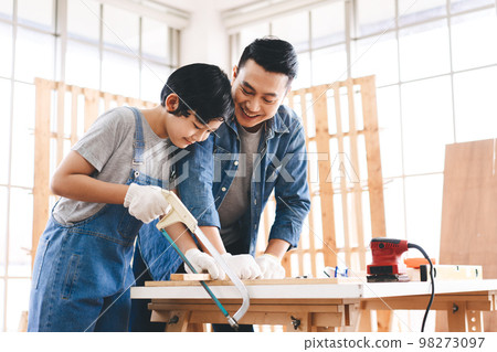 Southeast asian family father and son diy or repair for crafts skill at home workshop 98273097