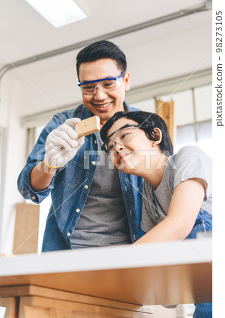 Southeast asian family father and son diy or repair for crafts skill at home workshop 98273105