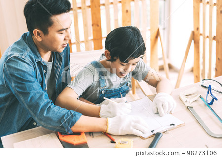 Southeast asian family father and son diy or repair for crafts skill at home workshop 98273106