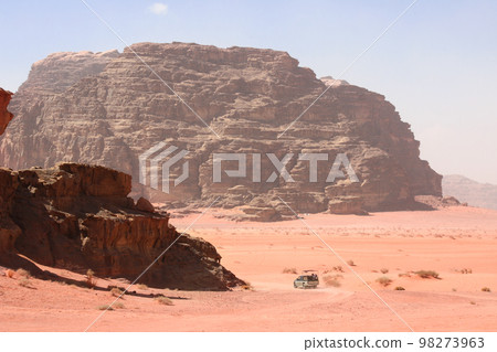 Car safari in Wadi Rum desert, Jordan. Tourists in car ride on off-road on sand among the beautiful rocks 98273963