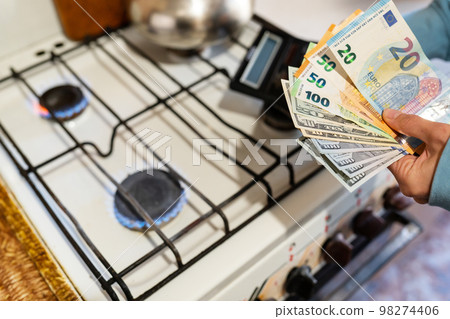 The family calculates gas and utility bills. Euro and dollar bills in hands. The concept of increasing the cost of natural gas supply and payment. Energy crisis. High cost, the price of gas. The family calculates gas and utility bills. Euro and dollar bills in hands. The concept of increasing the cost of natural gas supply and payment. Energy crisis. High cost, the price of gas. 98274406