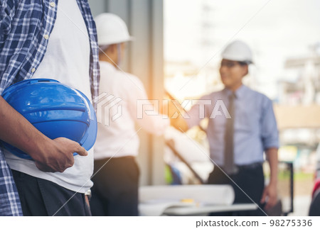 Civil engineer teams meeting working together wear worker helmets hardhat on construction site in modern city. Foreman industry project manager engineer teamwork. Asian industry professional team Civil engineer teams meeting working together wear worker helmets hardhat on construction site in modern city. Foreman industry project manager engineer teamwork. Asian industry professional team 98275336