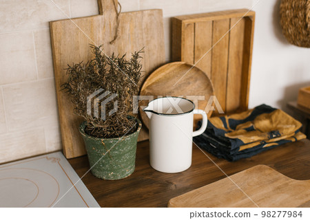 White metal milk jug, potted flowers, cutting board and kitchen decor 98277984