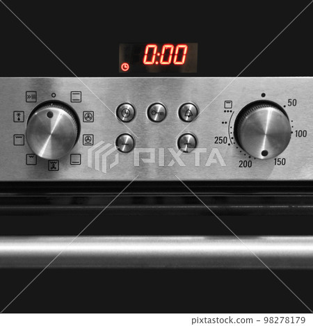 Modern kitchen has an oven and the control panel 98278179