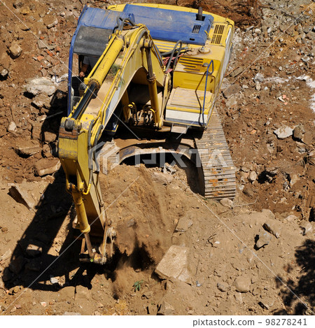 Excavator continues to work at the construction site Excavator continues to work at the construction site 98278241
