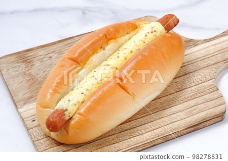 Side dish bread with plenty of mustard on coarse sausage Side dish bread with plenty of mustard on coarse sausage 98278831