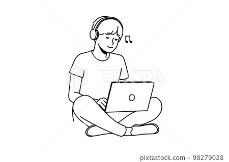 Guy sitting on grass with laptop and headphones  98279028