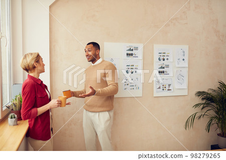 Smiling Colleagues Talking Office. Happy Business Couple Drinking Coffee Smiling Colleagues Talking Office. Happy Business Couple Drinking Coffee 98279265