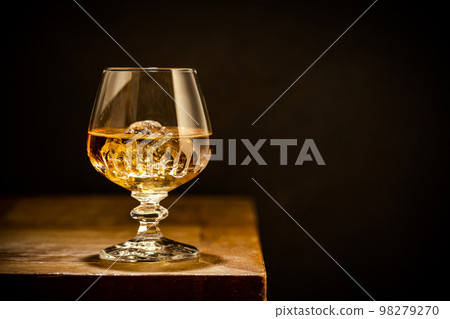 Glass of scotch whiskey and ice 98279270