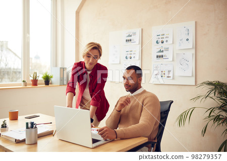 Smiling Colleagues Working Laptop Office. Happy Business Couple Using Computer Smiling Colleagues Working Laptop Office. Happy Business Couple Using Computer 98279357