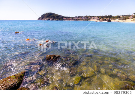 Swimmers training on the open sea / ocean. Swimmers training on the open sea / ocean. 98279365