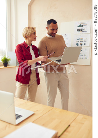Smiling Colleagues Working Laptop Office. Happy Business Couple Using Computer Smiling Colleagues Working Laptop Office. Happy Business Couple Using Computer 98279389
