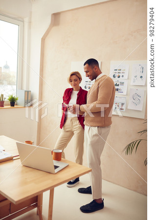 Happy Business People Using Smartphone. Smiling Colleagues Talking Office. Happy Business People Using Smartphone. Smiling Colleagues Talking Office. 98279404