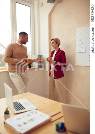 Smiling Colleagues Talking Office. Happy Business Couple Drinking Coffee 98279420